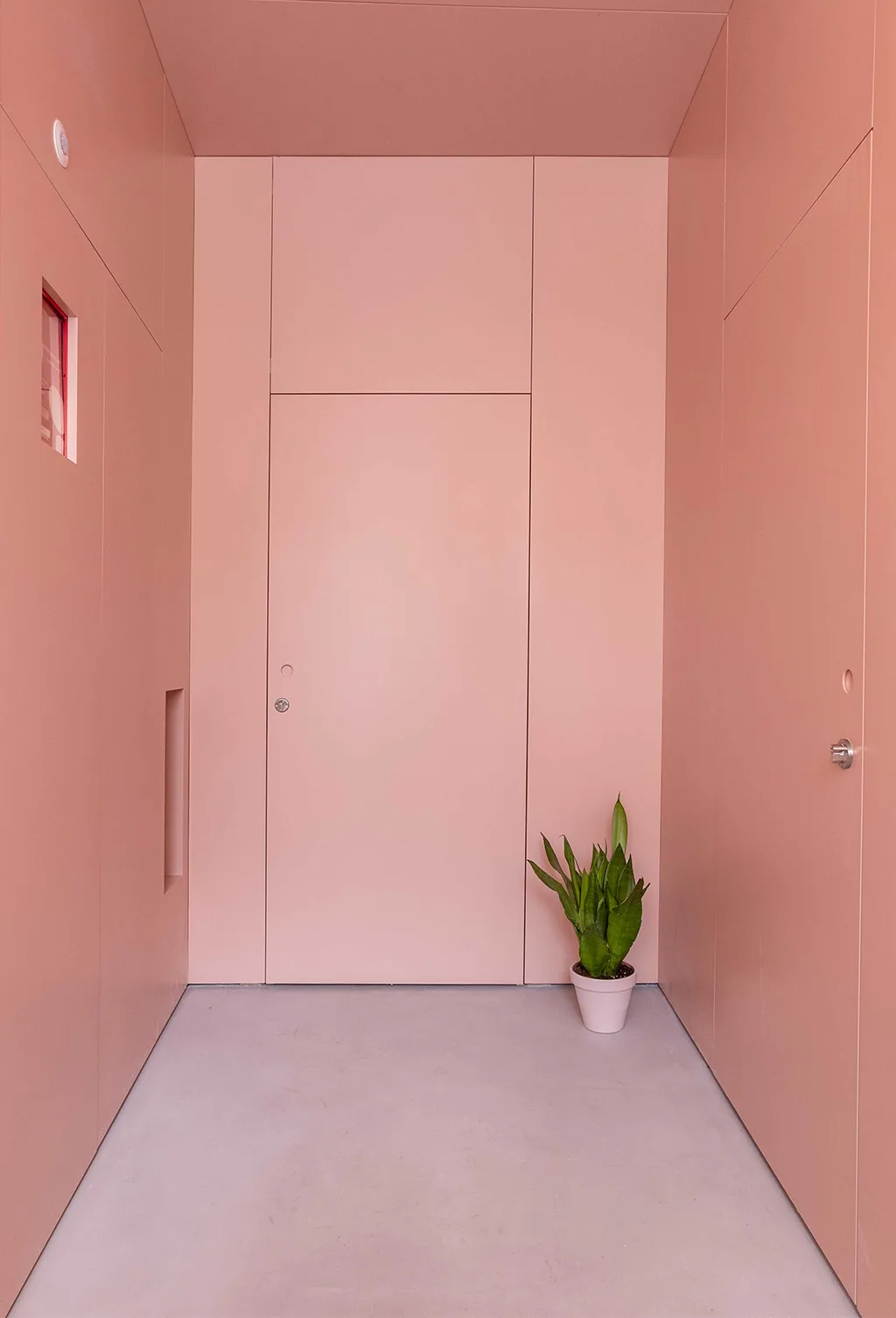 A pink hallway with full-height built-in joinery, by Rita Bessa Arquitectura